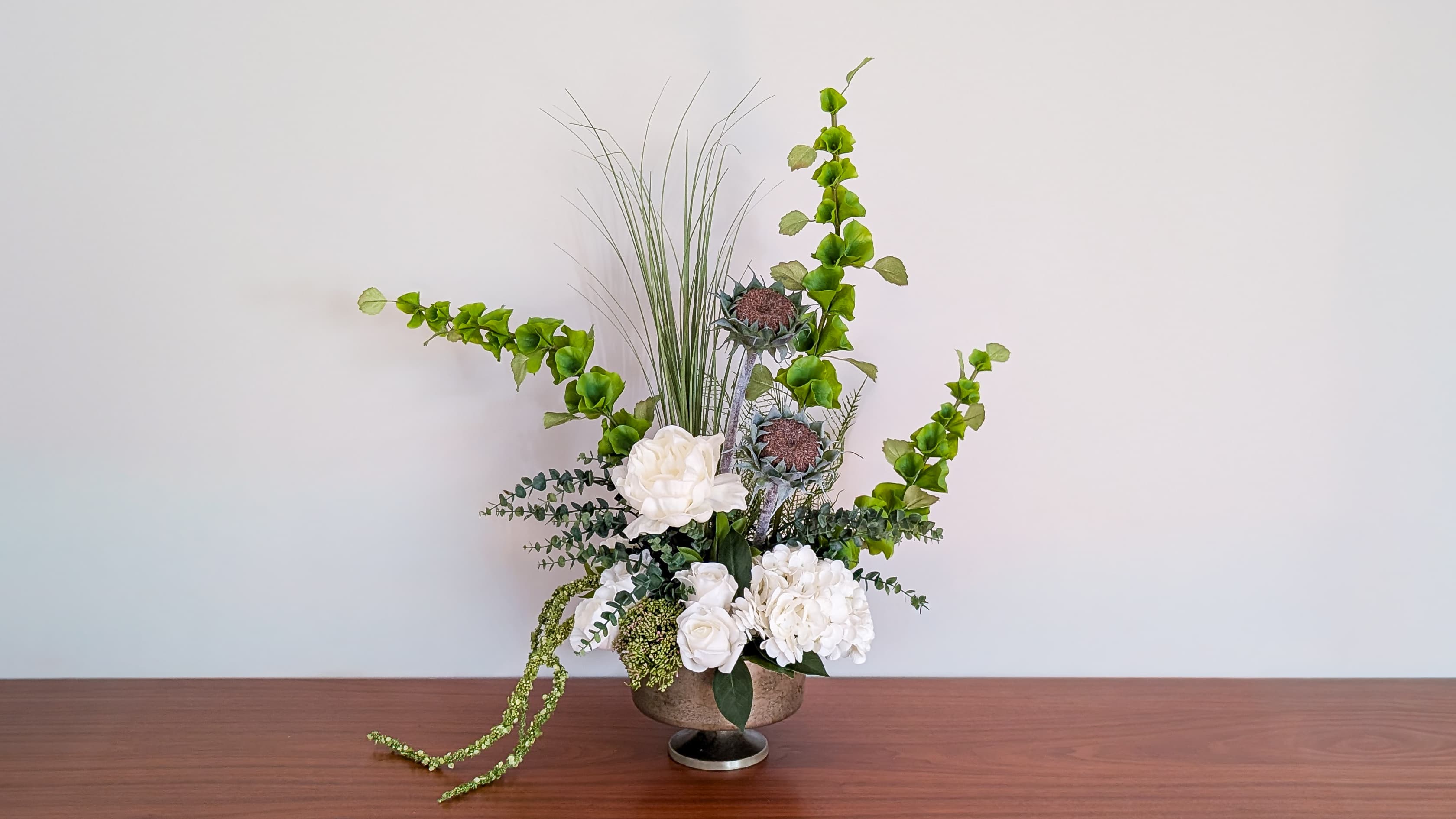 Circular floral centerpiece built from reused stems for a spa and wellness conference