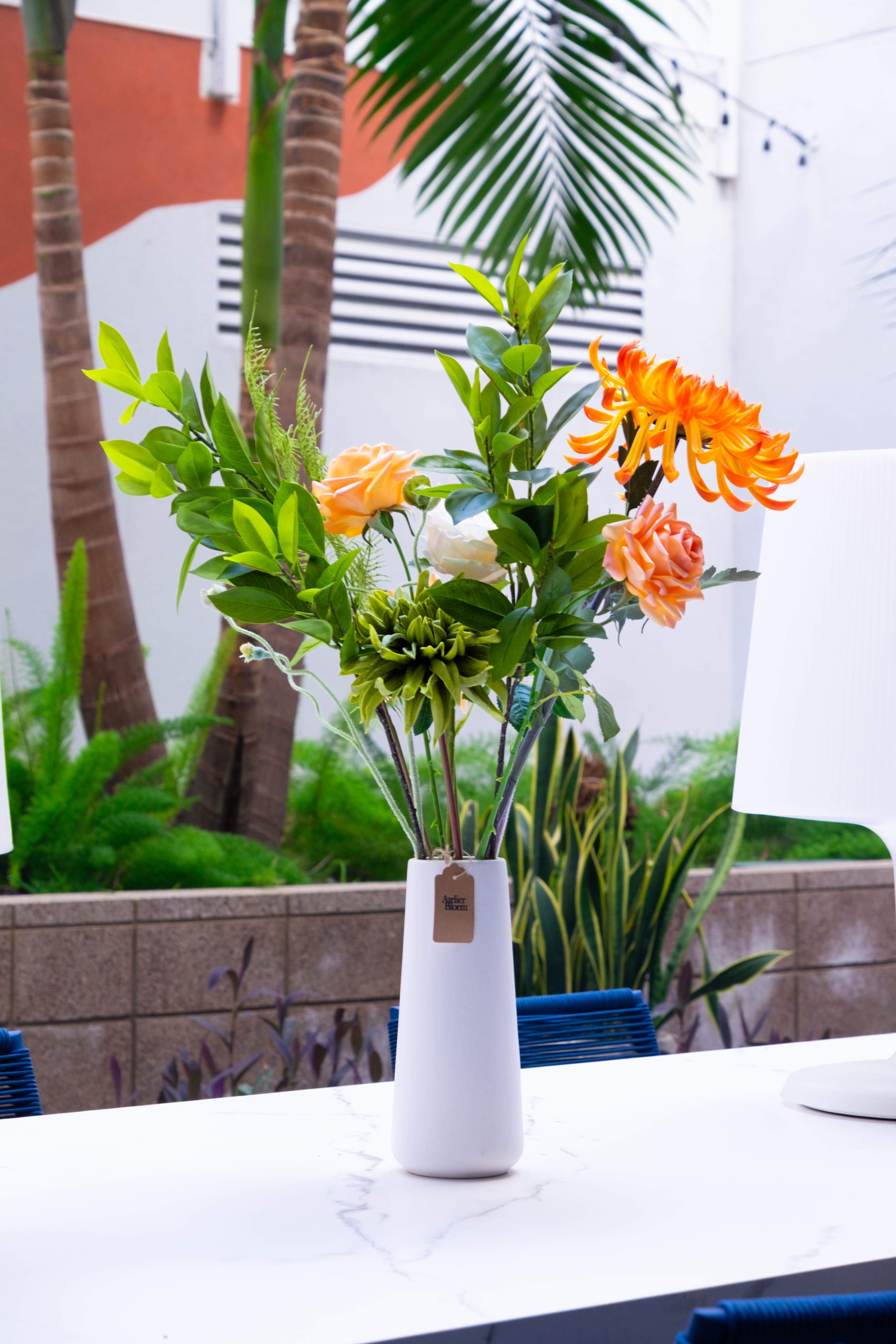 Monarch arrangement by Atelier Bloem on the community patio table at The Charlie Mar Vista